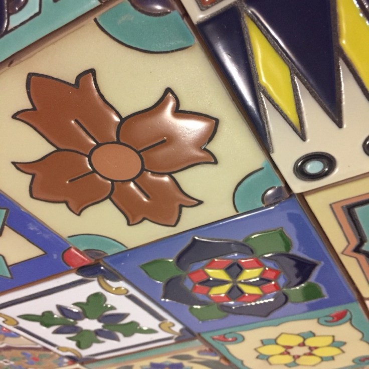 kitchen wall decorated with hand painted ceramic relief tiles