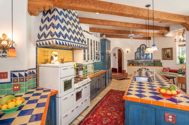 painted mexican talavera tiles installed on a kitchen wall